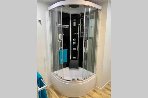 a shower with a glass door in a room at Tiny House in Belconnen 1BR Self Contained Wine in Higgins