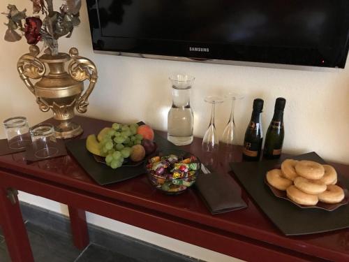 a table with a bunch of food and bottles of wine at Location Sardinia Borgo Antico XIX in Gesturi