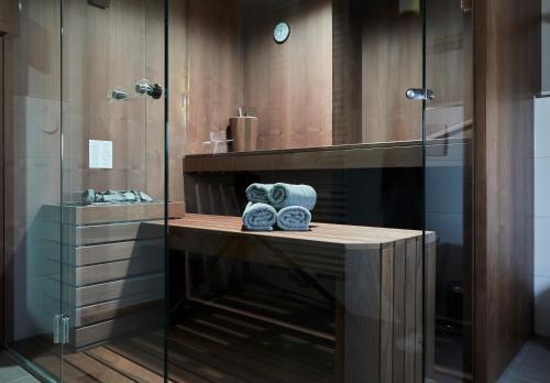 a bathroom with a glass shower with towels on a counter at Haus Ostsee in Göhren