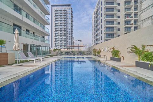 a swimming pool in the middle of a building at Stella Stays Elegant Studio Dubai JVC Private Balcony in Dubai