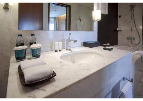 a bathroom with a sink and a large mirror at Luxury stay at Dubai Mall Residence Downtown in Dubai