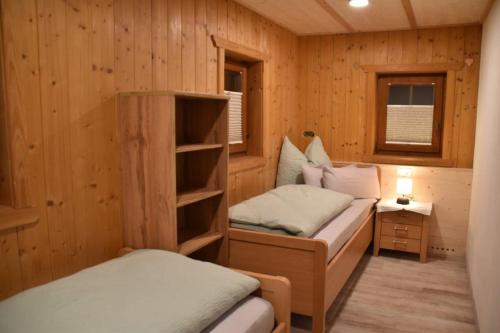 a small room with two beds in a cabin at Bacherhof in Söll
