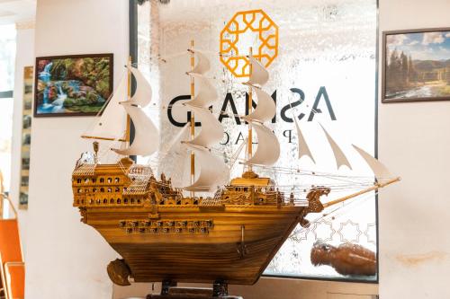 a model of a gun ship on display in a museum at Asmald Palace Hotel in Kokand