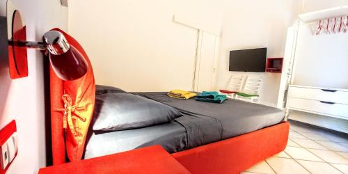 a bedroom with a bed and a lamp and a television at Casa Sunrise - Lovely sea front apartment in Sciacca