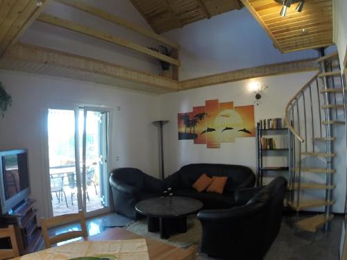 a living room with a couch and a table at Aspri Villa in Ammoudia