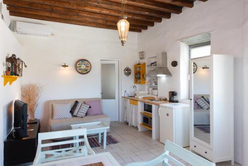 a kitchen and living room with white walls at Dora's traditional houses in Apollonia