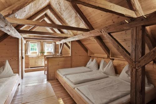 a room with two beds in a attic at Das Dorf in der Stadt in Schladming