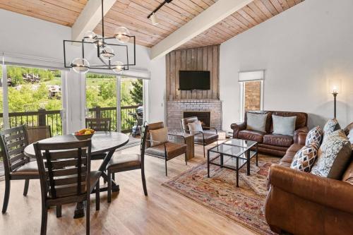 a living room with a couch and a table at Woodbridge Unit 29E in Snowmass Village