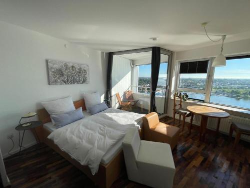 a bedroom with a bed and a large window at Inselblick in Schleswig