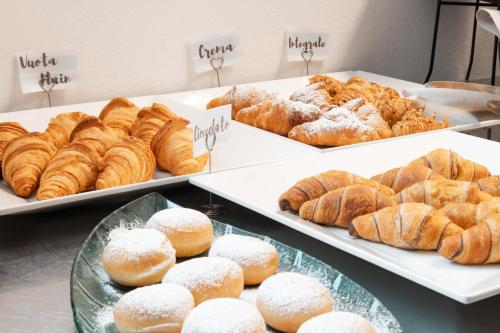 a bunch of pastries on trays in a bakery at Torbole Aparthotel in Nago-Torbole