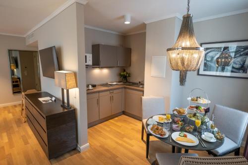 a living room with a table with food on it at VILA VITA Rosenpark in Marburg an der Lahn