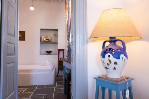 a lamp sitting on a table next to a bathroom at Dora's traditional houses in Apollonia