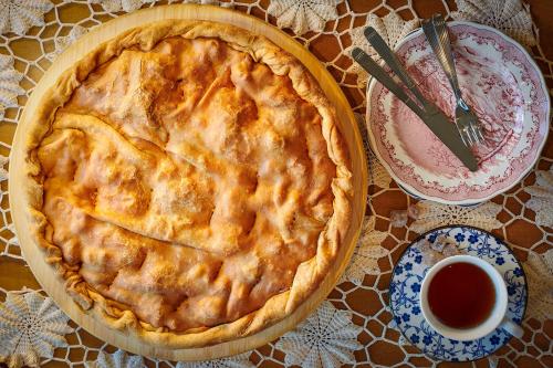 a pie sitting on a table next to a cup of tea at Tourist Boutique Hotel in Argostoli