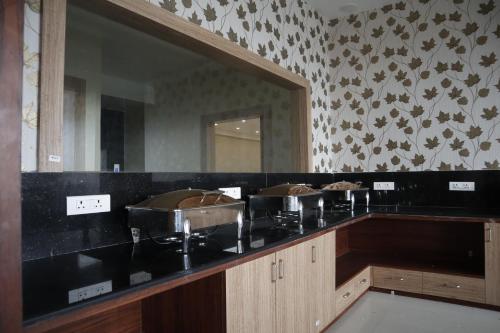 a bathroom with a sink and a mirror at Nilay Residency in Bhubaneshwar