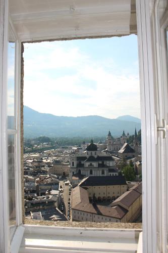a view of a city from a window at Stadtalm Naturfreundehaus in Salzburg