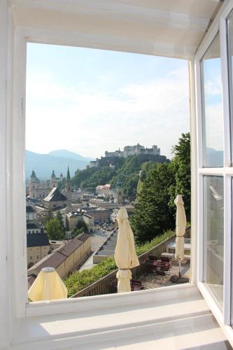 a window with a view of a city at Stadtalm Naturfreundehaus in Salzburg