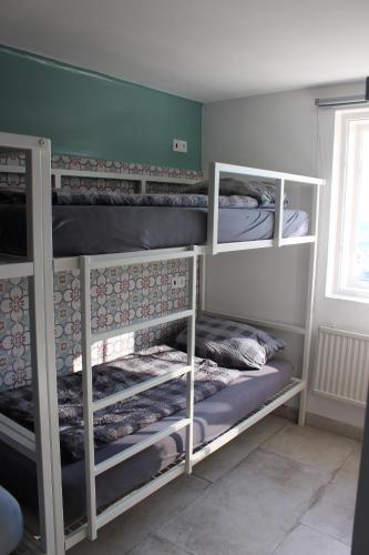 a room with three bunk beds in a room at Stadtalm Naturfreundehaus in Salzburg