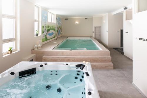 a bathroom with a jacuzzi tub in a house at Hotel & Wellness Stella Delle Langhe in Govone