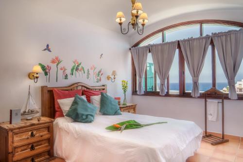 a bedroom with a bed with a large window at Apartamentos Cancajos in Los Cancajos