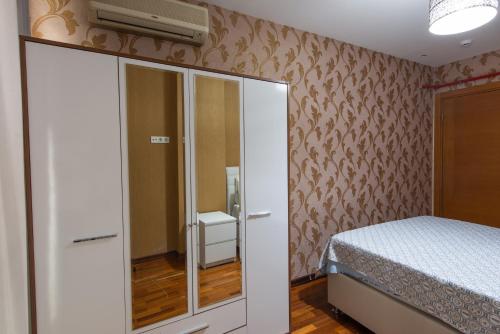 a small bedroom with a bed and a closet at CTS Elysium Residence Taksim in Istanbul