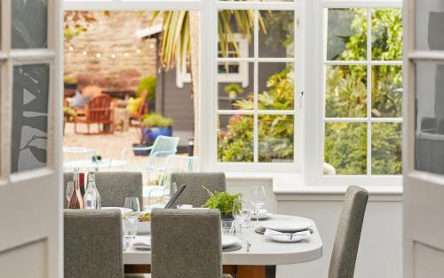 a dining room with tables and chairs and windows at 94DR in Edinburgh