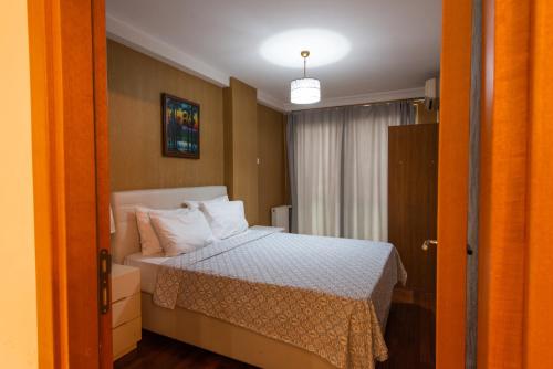a bedroom with a bed with white pillows at CTS Elysium Residence Taksim in Istanbul
