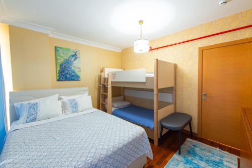 a bedroom with a bed and a bunk bed at CTS Elysium Residence Taksim in Istanbul