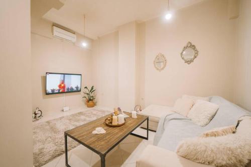 a living room with a couch and a table at Debbie's House in Kalamata