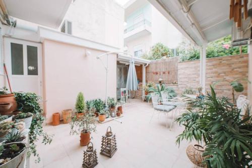 a patio with potted plants and a table at Debbie's House in Kalamata