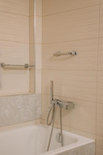 a bathroom with a shower and a tub and a sink at Debbie's House in Kalamata