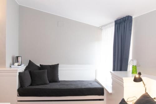 a bed in a white room with a window at Hotel Clitunno in Spoleto