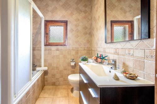 a bathroom with a sink and a toilet at Villa La Vinya Can Oliver - Oliver in Pollença