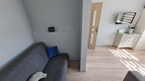 a living room with a couch and a hallway at SP Apartment Klaipedas street close to beach in Liepāja