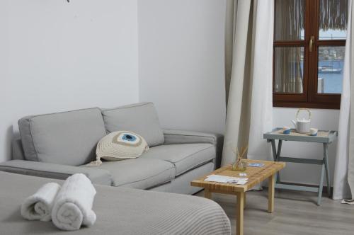 a living room with a couch and a table at Syros Wellness Luxury Suites in Finikas
