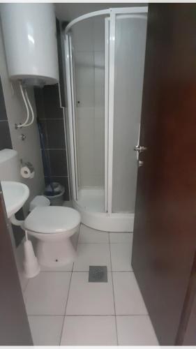 a bathroom with a shower and a toilet and a sink at POP MARKOV in Ohrid