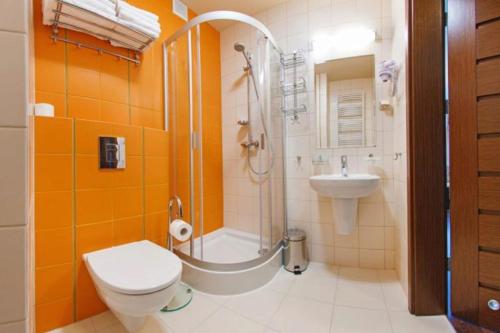 a bathroom with a shower and a toilet and a sink at Foka, Sun & Snow in Hel