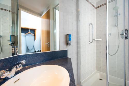 La salle de bains est pourvue d'un lavabo et d'une douche. dans l'établissement Holiday Inn Express Derby Pride Park, an IHG Hotel, à Derby
