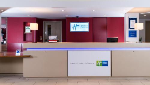 a room with a large screen tv on the wall at Holiday Inn Express Derby Pride Park, an IHG Hotel in Derby