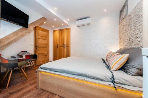 a small bedroom with a bed and a desk at Ground Floor Gem (city centre) in Rovinj