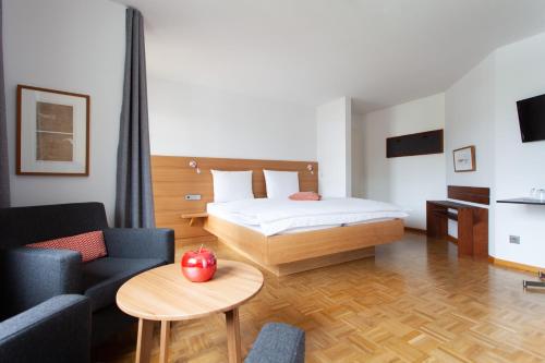 a bedroom with a bed and a table with an apple at Storchen Restaurant Hotel in Bad Krozingen