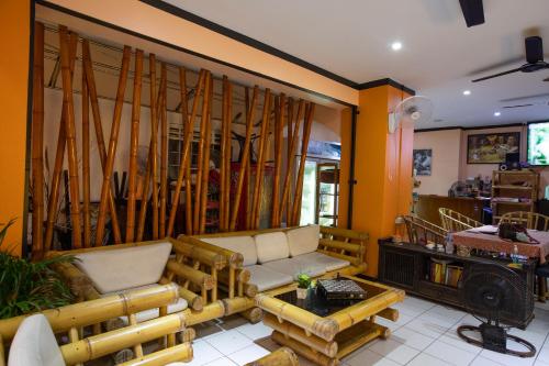 a living room with a couch and wooden furniture at Hotel Sole in Patong Beach