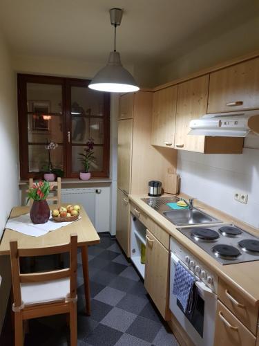 a kitchen with a table and a stove top oven at fewofelix in Würzburg