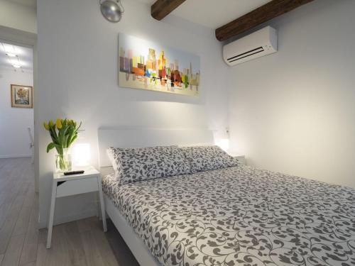 a white bedroom with a bed and a white wall at Residence SS Giovanni e Paolo in Venice