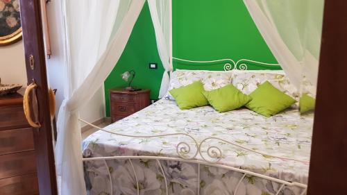 a bedroom with a bed with a green wall at Amanda's Dream in Taranto