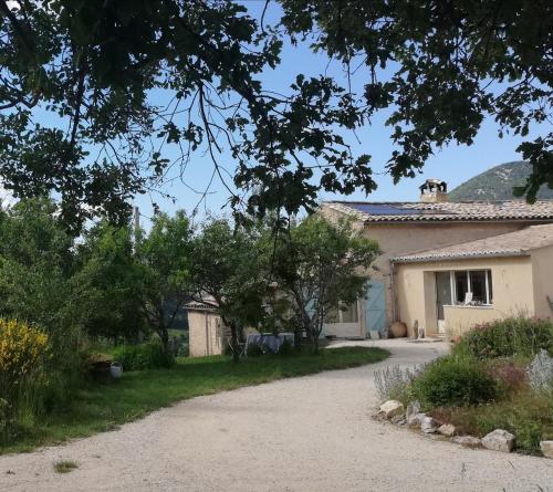a house with a driveway in front of it at La Farigoule in Montbrun-les-Bains