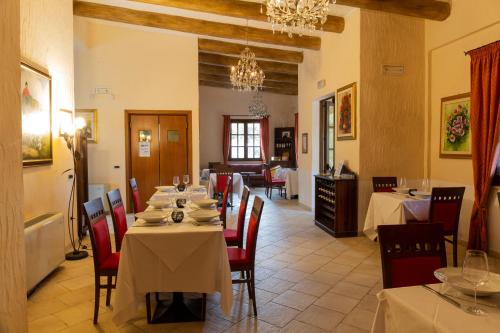 a dining room with tables and chairs in a restaurant at Is Benas Country Lodge in San Vero Milis
