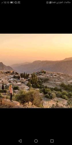 a woman standing on top of a hill with a view at Dana Tower Hotel in Dana