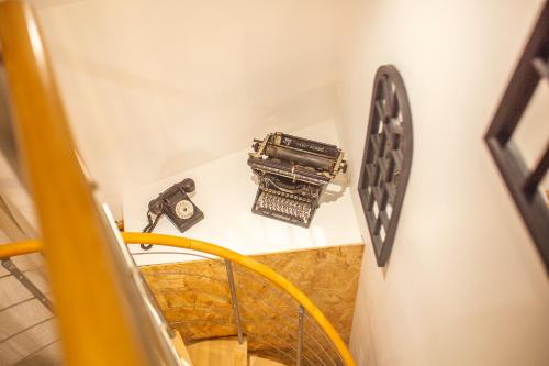 a stairway with a clock on a wall at L'Escapade à Lascaux in Montignac