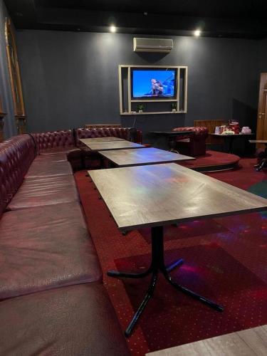 a room with several tables and a flat screen tv at Отель Ренессанс in Dnipro
