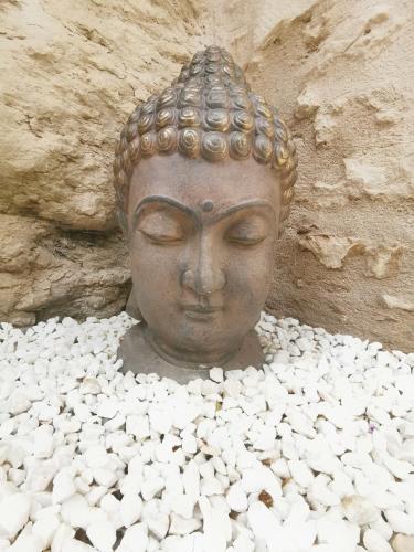 a statue sitting on top of a pile of white rocks at L'Escapade à Lascaux in Montignac